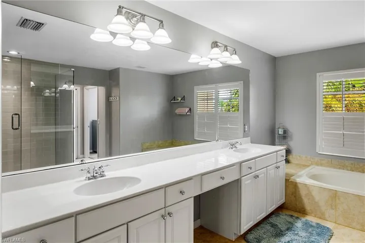 Bathroom featuring vanity and plus walk in shower