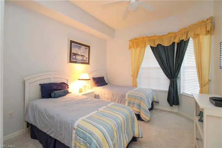 Bedroom featuring ceiling fan and light carpet