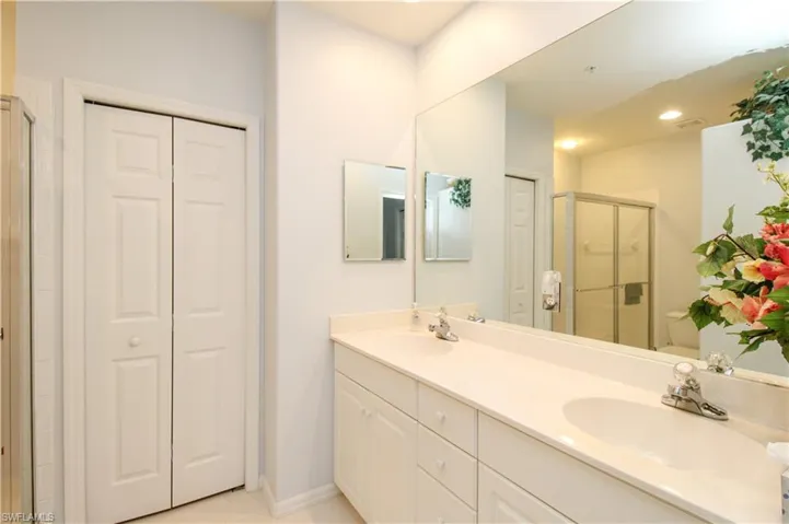 Bathroom with vanity, toilet, and a shower with door