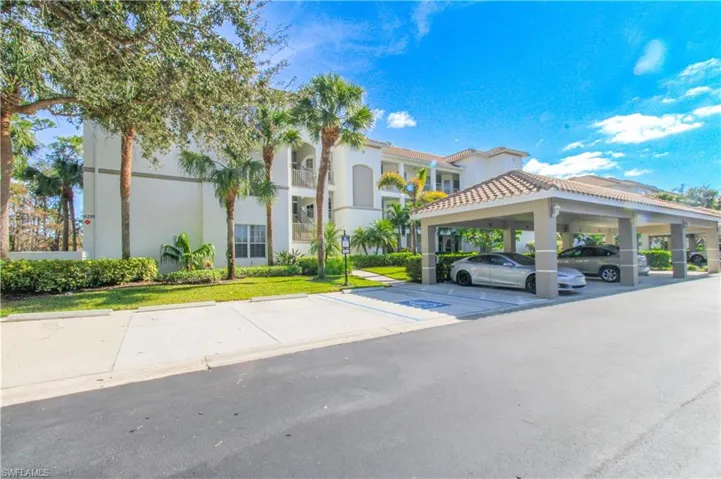 View of vehicle parking featuring a carport & guest parking spot