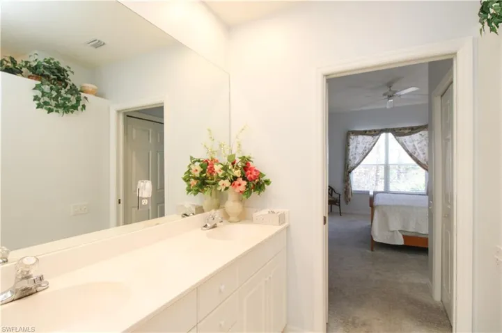 Bathroom with ceiling fan and vanity