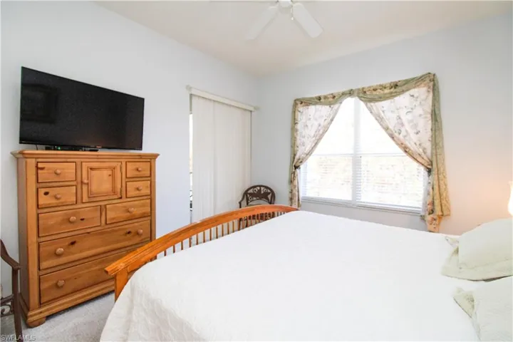 Carpeted bedroom with ceiling fan