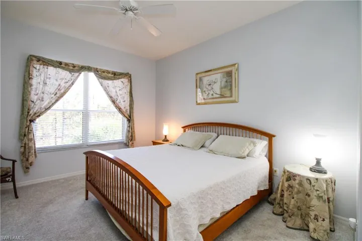 Carpeted bedroom with ceiling fan