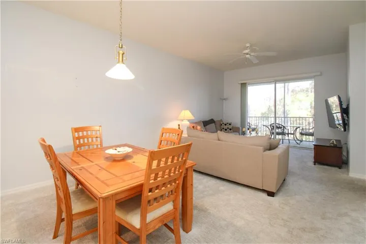 Dining room featuring light colored carpet and ceiling fan