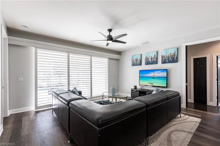 Living room featuring dark hardwood / wood-style flooring and ceiling fan