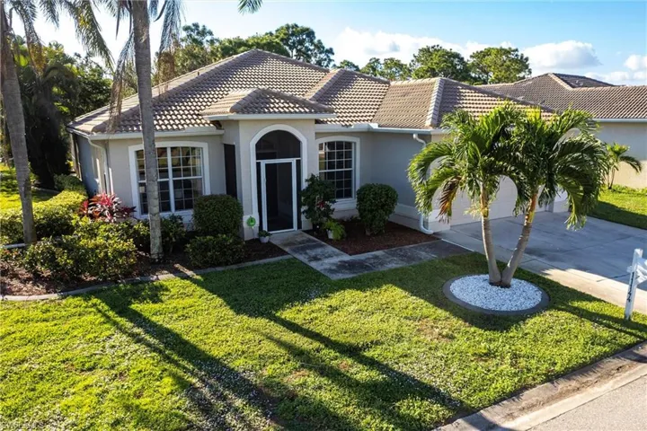 Mediterranean / spanish house with a garage and a front yard