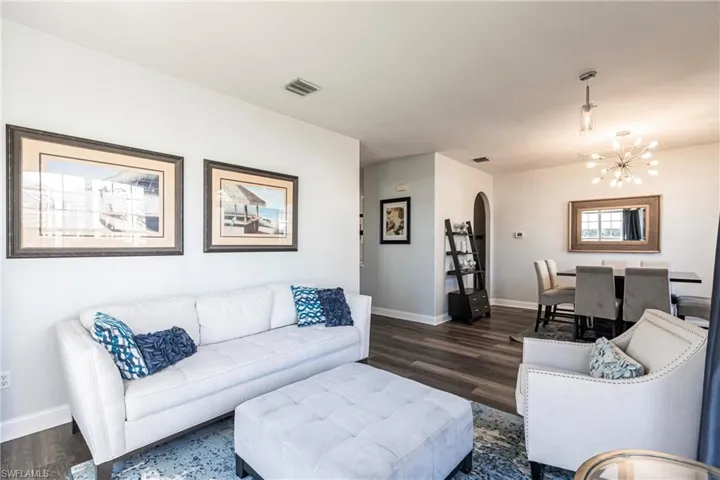 Living room featuring dark hardwood / wood-style floors and a notable chandelier