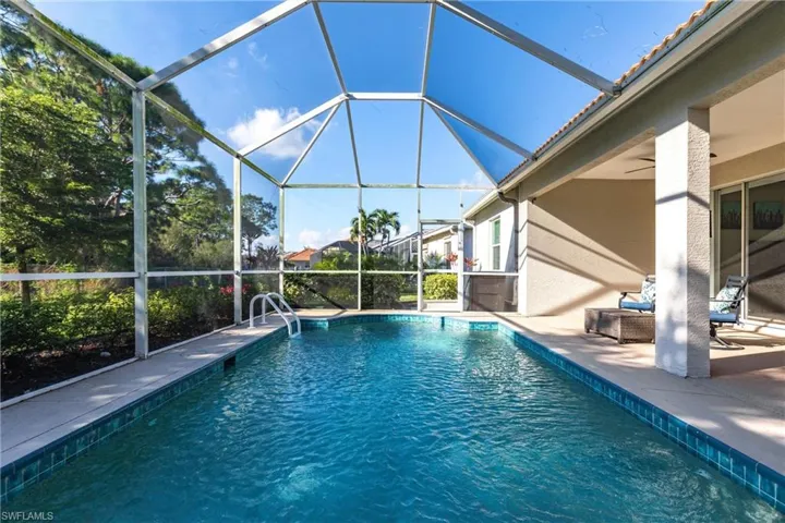 View of swimming pool featuring ceiling fan and a patio area