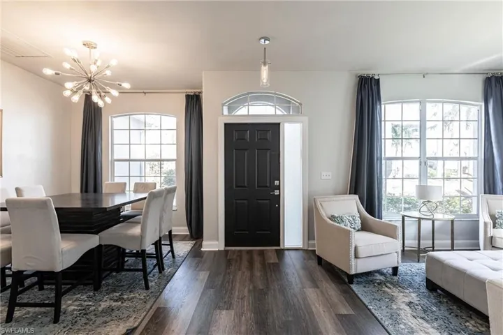 Entryway with dark hardwood / wood-style flooring and a notable chandelier
