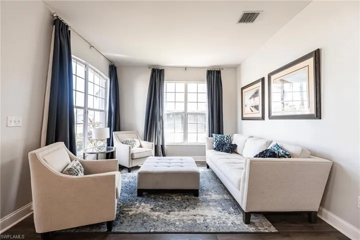 Living room with dark wood-type flooring