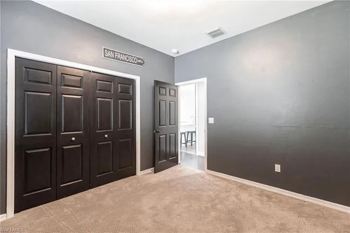 Bedroom featuring a closet and light colored carpet