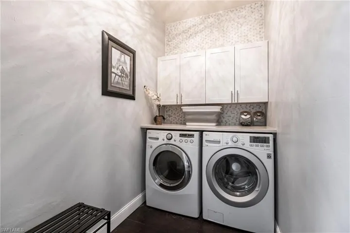 Laundry room with cabinets and washing machine and dryer