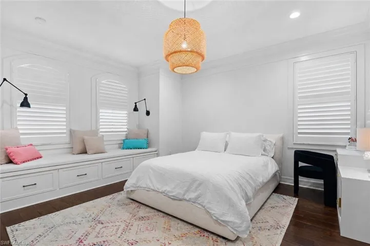 Interior room featuring dark wood-finish flooring and white walls