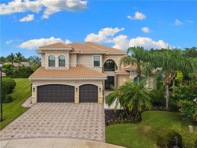 Mediterranean-style residence featuring a tile roof and stucco exterior
