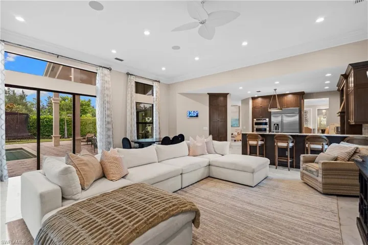 Open-concept living area featuring high ceilings with recessed lighting and a ceiling fan
