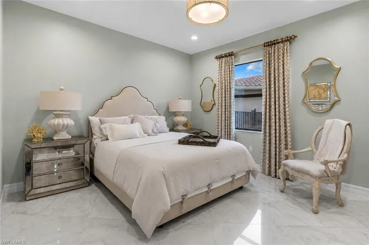 Interior space featuring light-toned walls, a single window with decorative drapery, and polished tile flooring