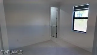 Empty room featuring baseboards
