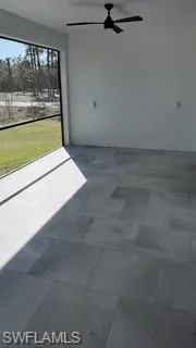 View of patio / terrace with a ceiling fan and a sunroom