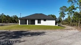 View of side of home featuring a lawn