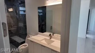Full bathroom with vanity and a stall shower