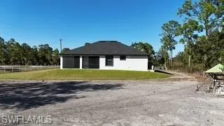 View of side of property featuring a lawn