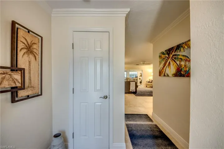 Hallway featuring tile patterned floors and ornamental molding