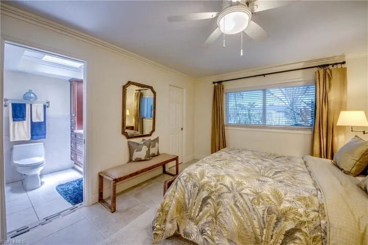 Bedroom featuring tile patterned flooring, ceiling fan, and ornamental molding