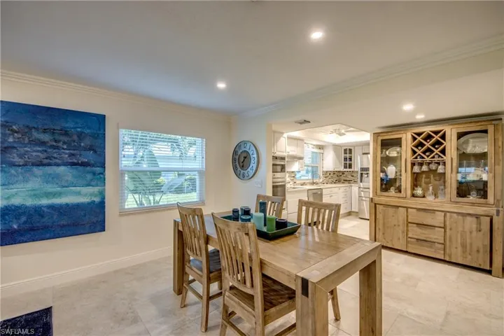 Dining area featuring ornamental molding and light tile patterned floors