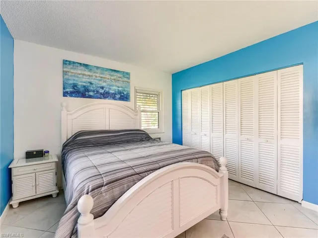 Bedroom with a textured ceiling and a closet