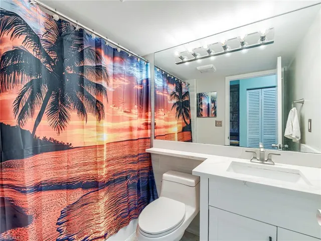 Bathroom with vanity and curtained shower