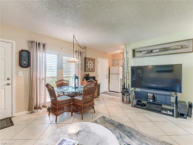 Dining area featuring a textured ceiling and light tile patterned flooring