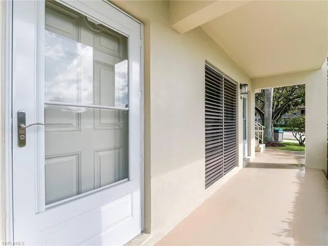 Doorway to property featuring stucco siding