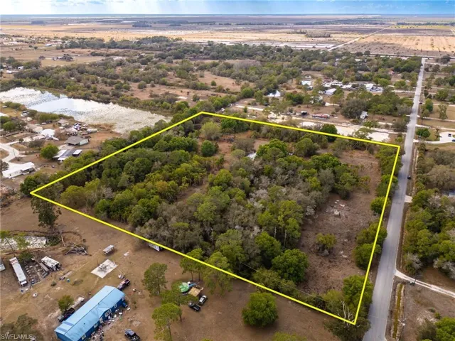 Aerial view of property and surrounding area featuring property boundaries highlighted