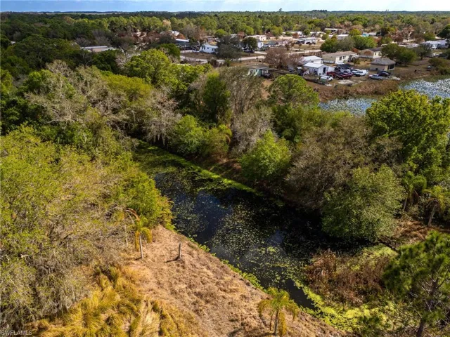 Aerial view of a large body of water and a tree filled landscape