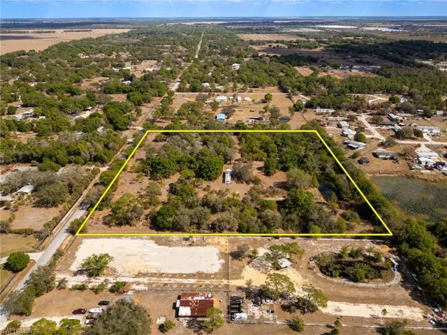 Aerial view of property and surrounding area with property parcel outlined