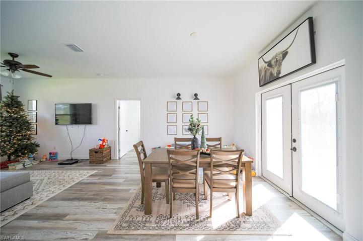 Large Dining Area With Double Glass French Doors Leading Out To The Back Yard!!