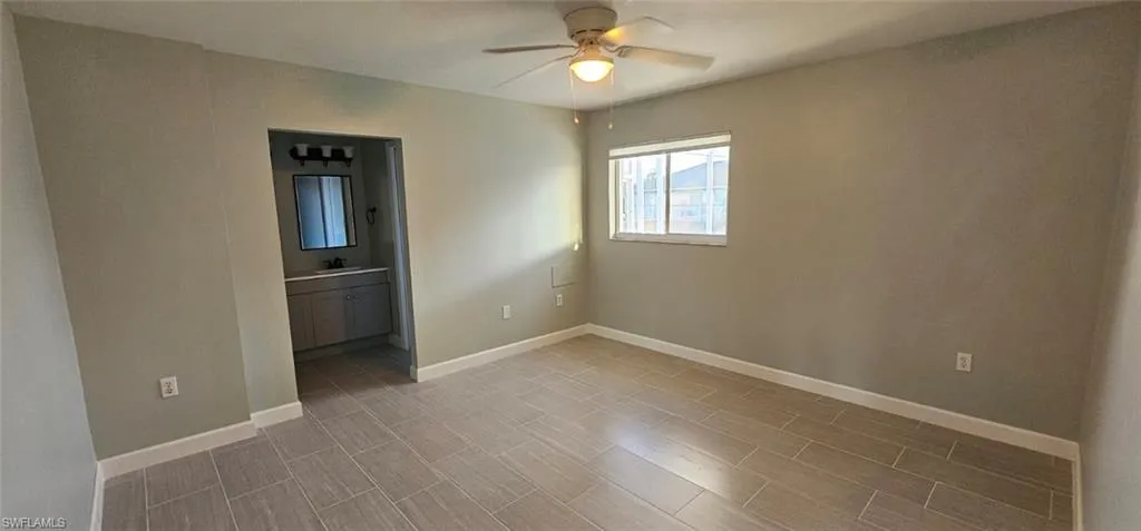 Empty room featuring ceiling fan and wood finish floors