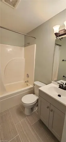 Bathroom with vanity and shower / bathtub combination with curtain
