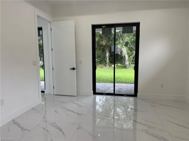 Spare room featuring baseboards
