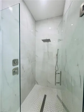 Bathroom with a marble finish shower