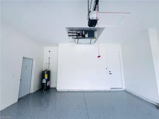 Garage with water heater and a garage door opener