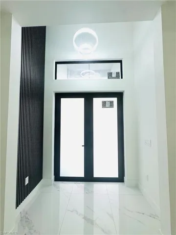 Foyer, entrance featuring custom ceiling lamp