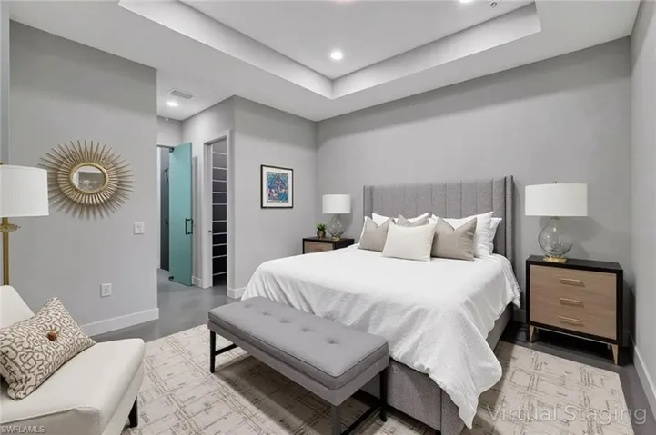 Virtual staged - Bedroom featuring a tray ceiling and recessed lighting