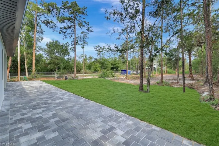 View of green lawn featuring a patio area