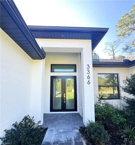 View of exterior entry featuring stucco siding