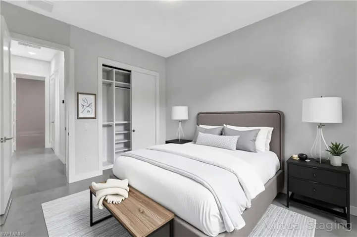 Virtual staged - Bedroom with a closet and finished concrete flooring