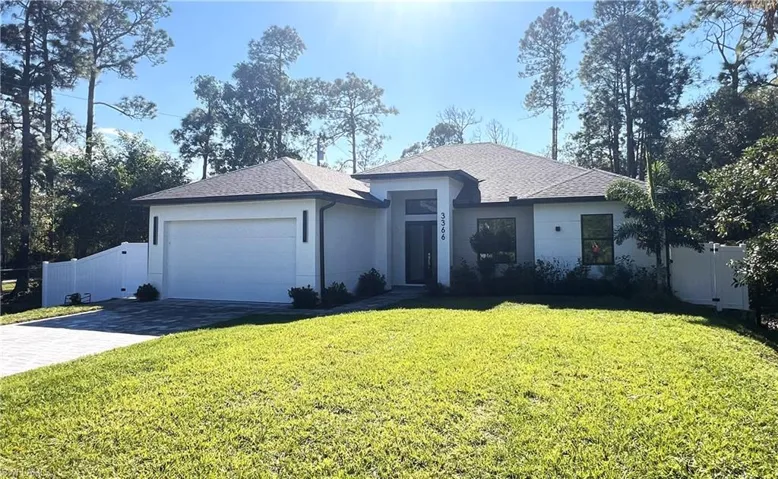 View of front of house featuring decorative driveway, a shingled roof, a garage, and stucco siding