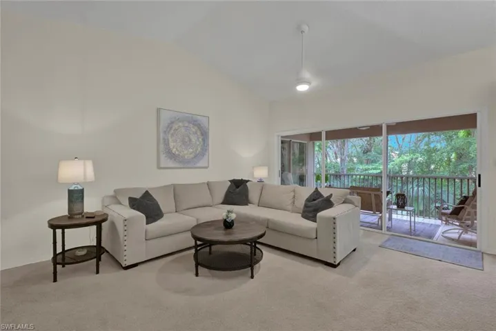 Living room featuring carpet and lofted ceiling