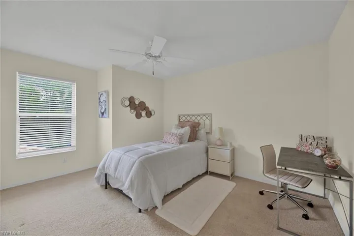 Bedroom featuring carpet flooring, a ceiling fan, and an office area