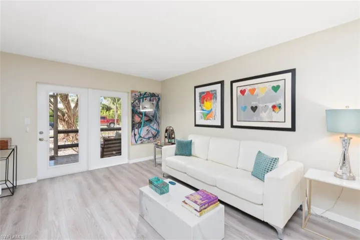 Living room with light hardwood / wood-style floors